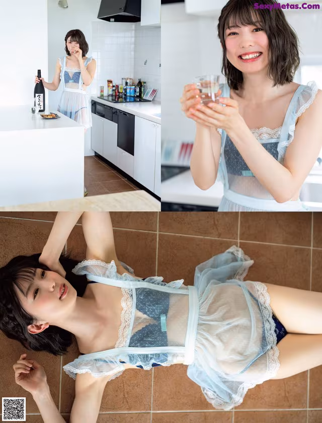 A woman in a blue lingerie holding a glass of wine.