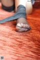 A close up of a woman's feet in black stockings.