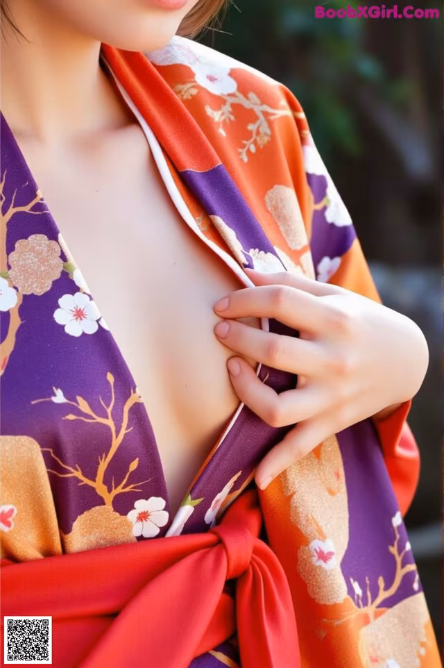 A woman wearing a purple and orange kimono is posing for a picture.