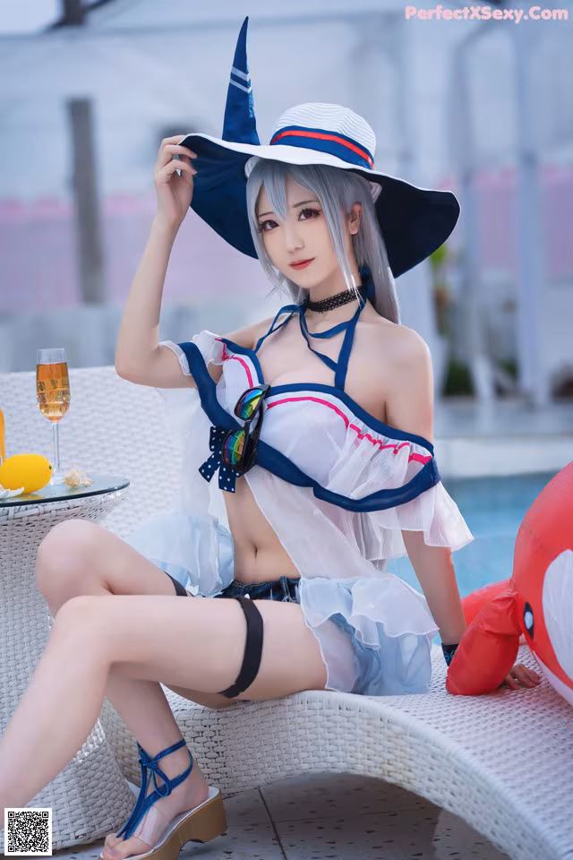 A woman in a sailor outfit sitting on a lounge chair.
