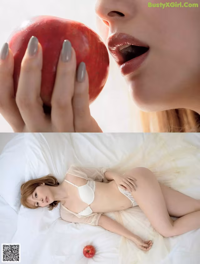 A woman laying on a bed holding an apple.