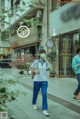 A woman wearing a face mask walking down a street.