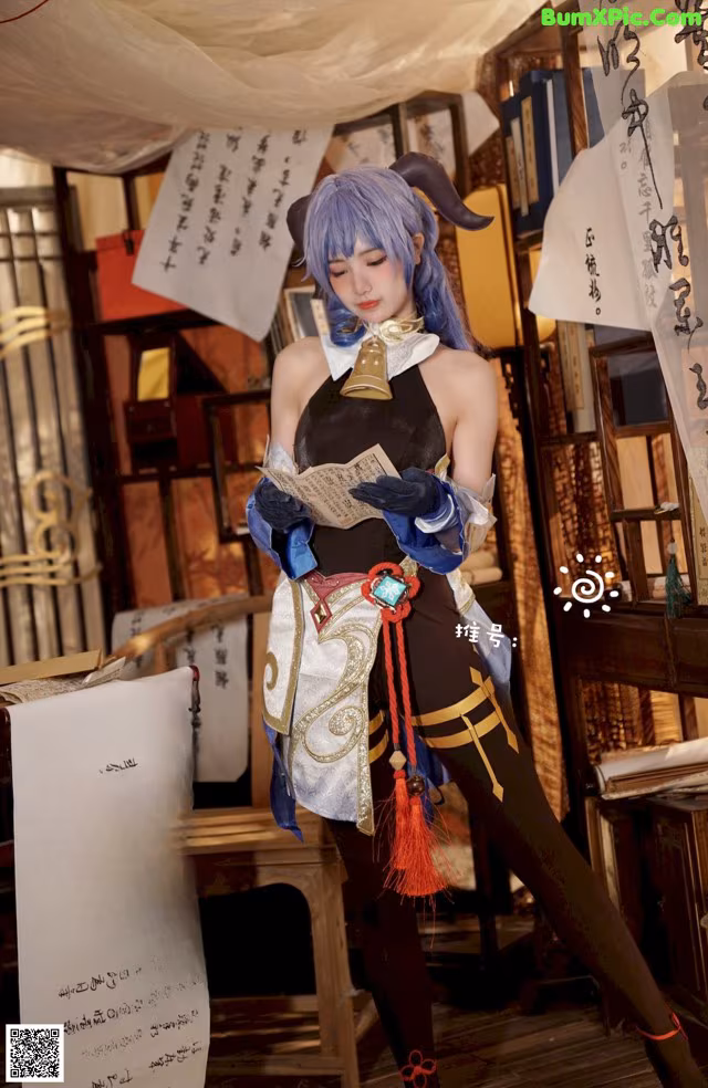 A woman dressed in a cosplay costume holding a book.